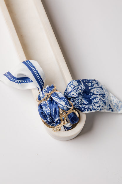 White with blue decorative bracelet bandana and gold accents on a white background