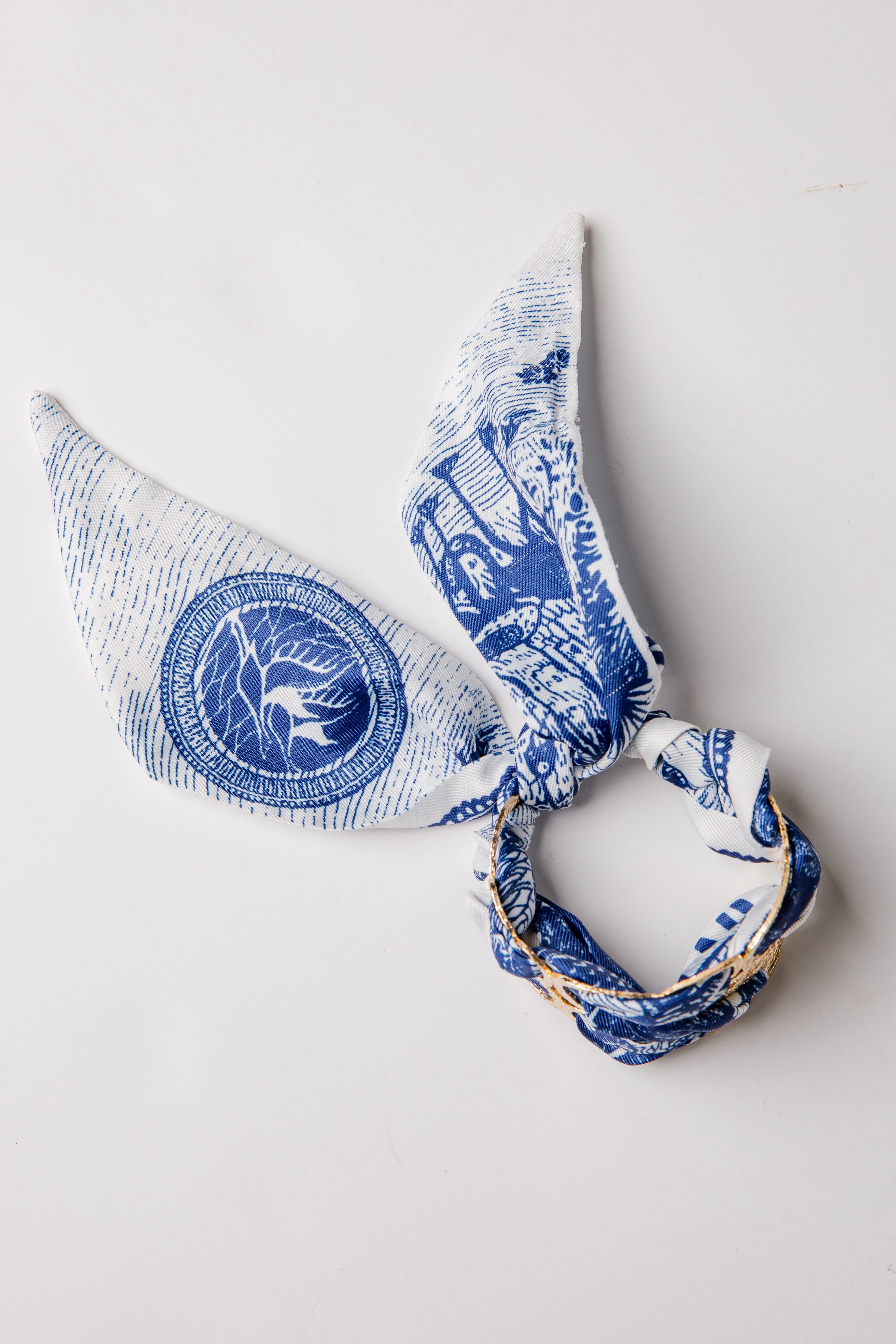 Blue and white patterned headscarf on a light gray background