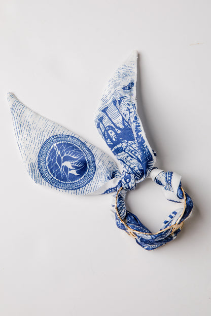 Blue and white patterned headscarf on a light gray background