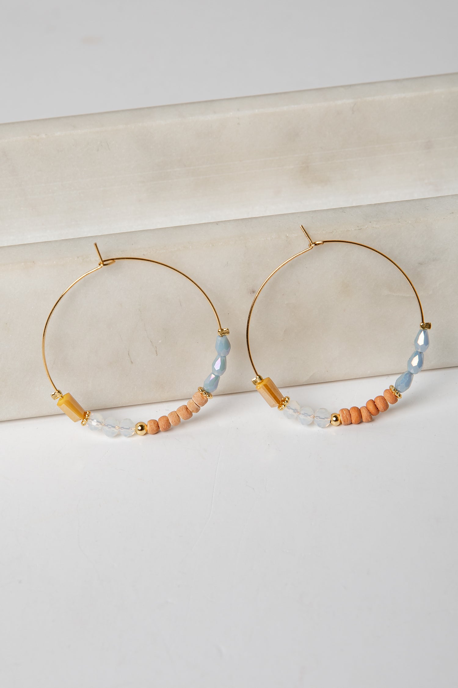 Hoop earrings with beaded accents on a light background