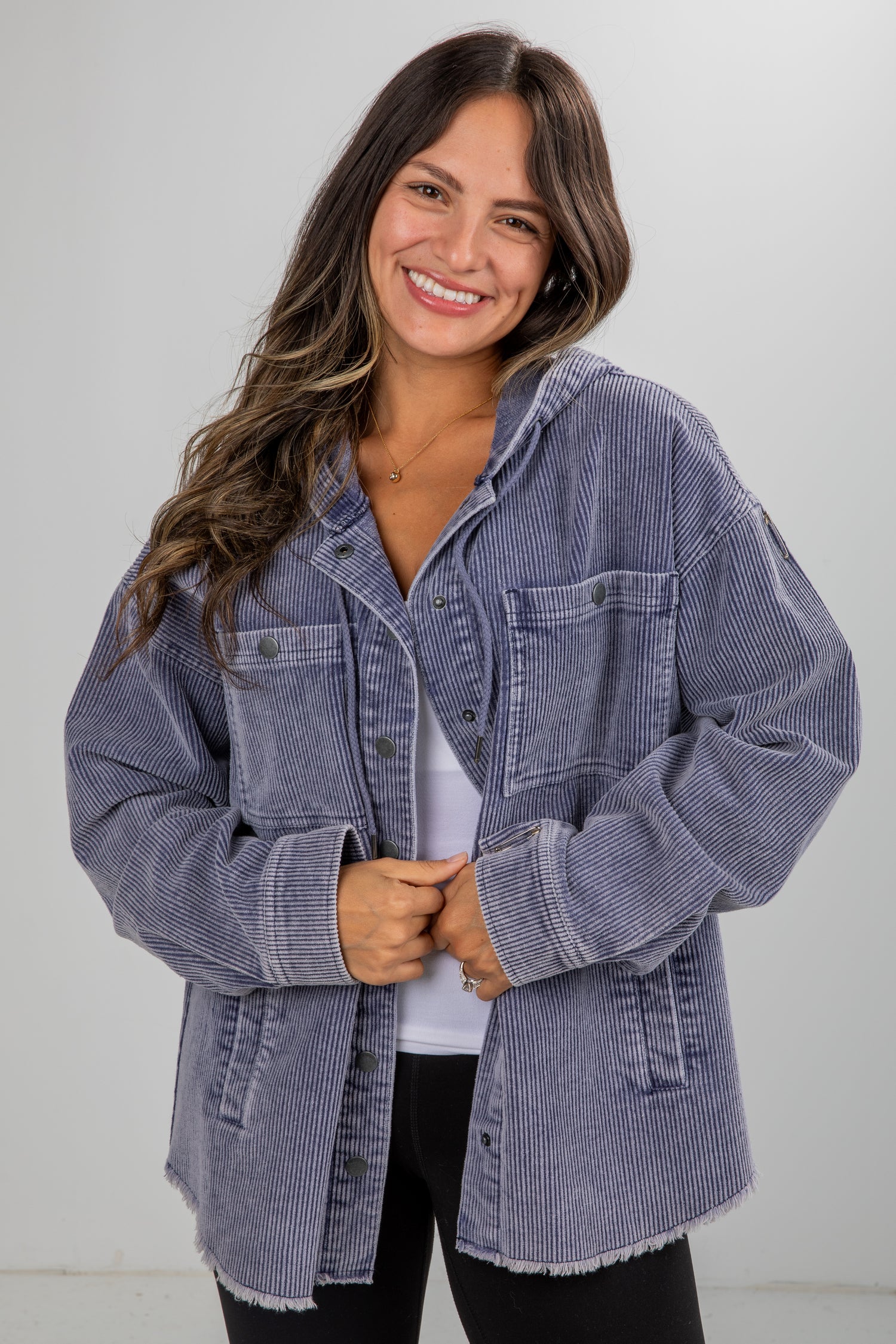 Woman wearing a blue denim jacket against a white background