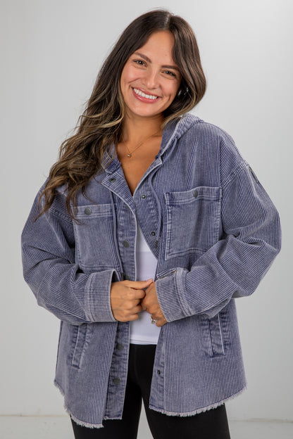 Woman wearing a blue denim jacket against a white background