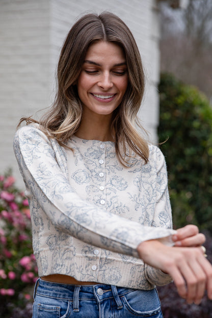 Woman wearing a floral blouse and jeans outdoors