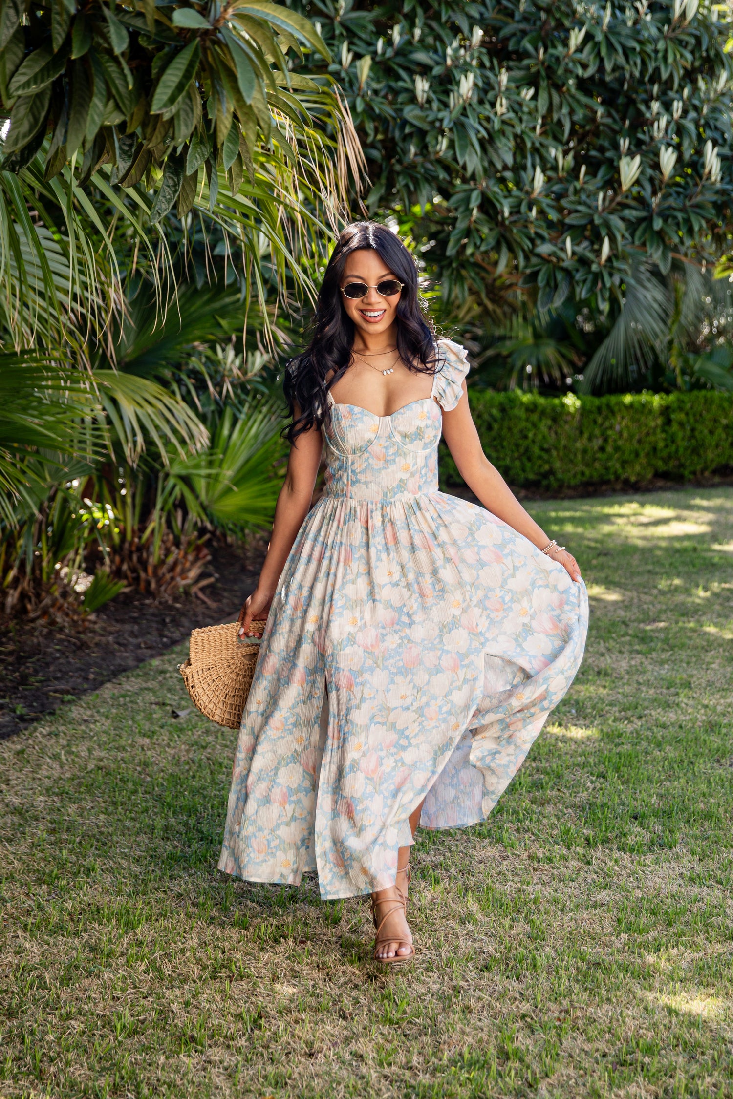 Woman in a floral dress standing in a garden
