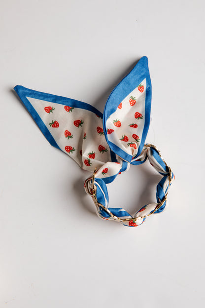 Decorative bracelet with strawberry pattern on a white background