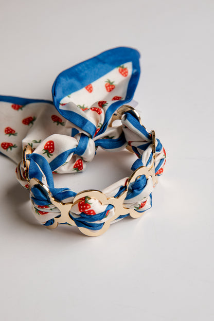 Braided bracelet with floral pattern on a light gray background