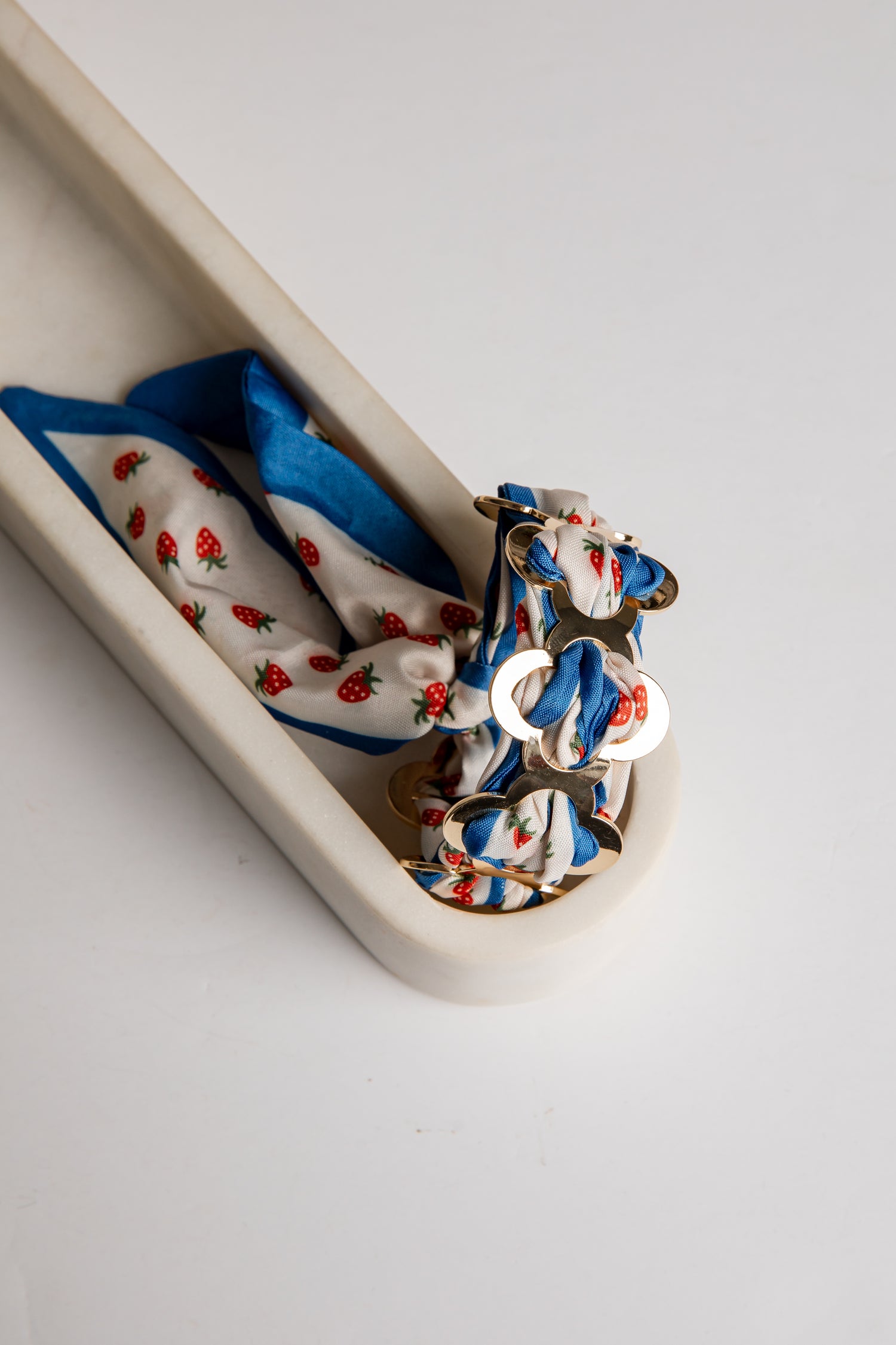 Set of colorful bracelet with strawberry pattern on a white tray