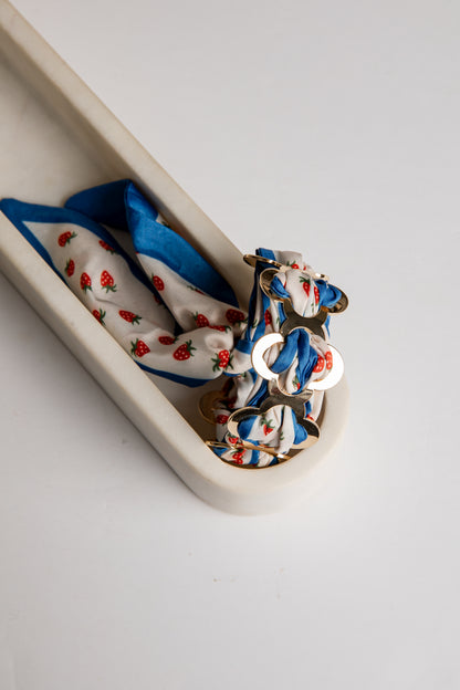 Set of colorful bracelet with strawberry pattern on a white tray