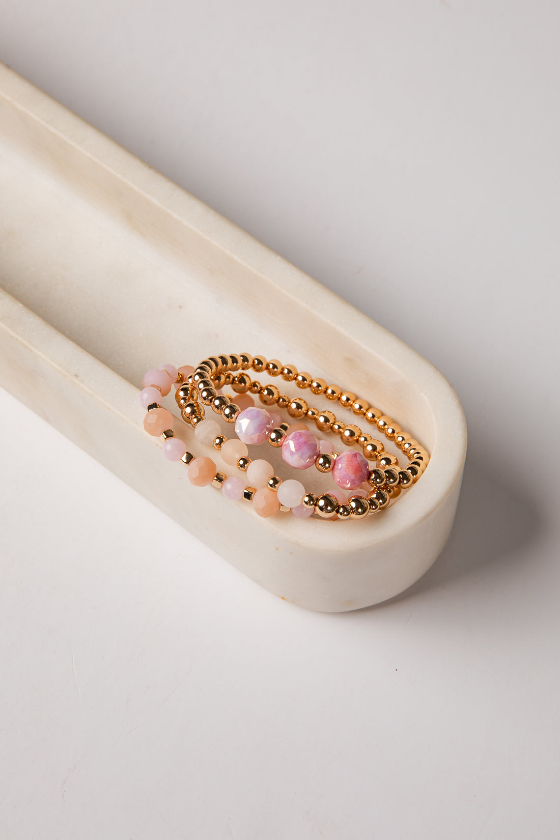 Set of beaded bracelets on a white surface