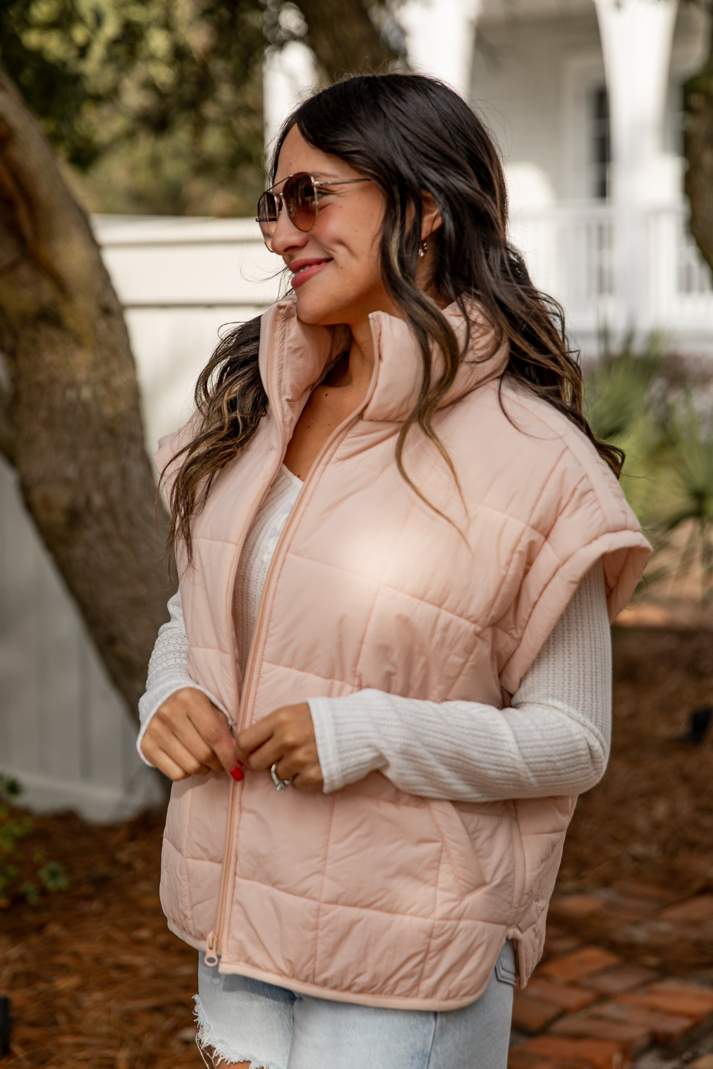 Woman wearing a pink puffer vest outdoors