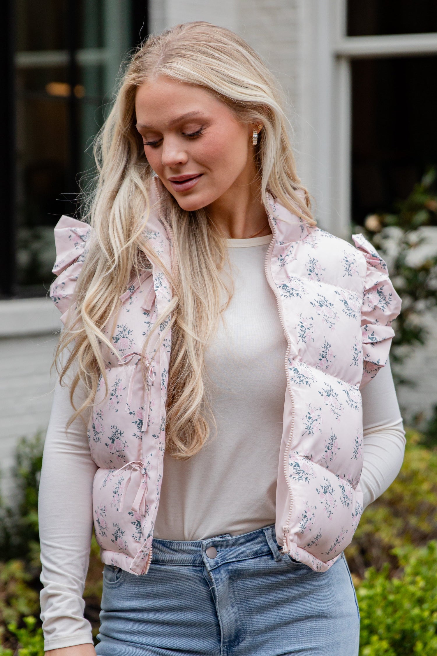 Woman wearing a floral puffer vest outdoors