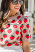 Woman wearing a sweater with strawberry pattern outdoors