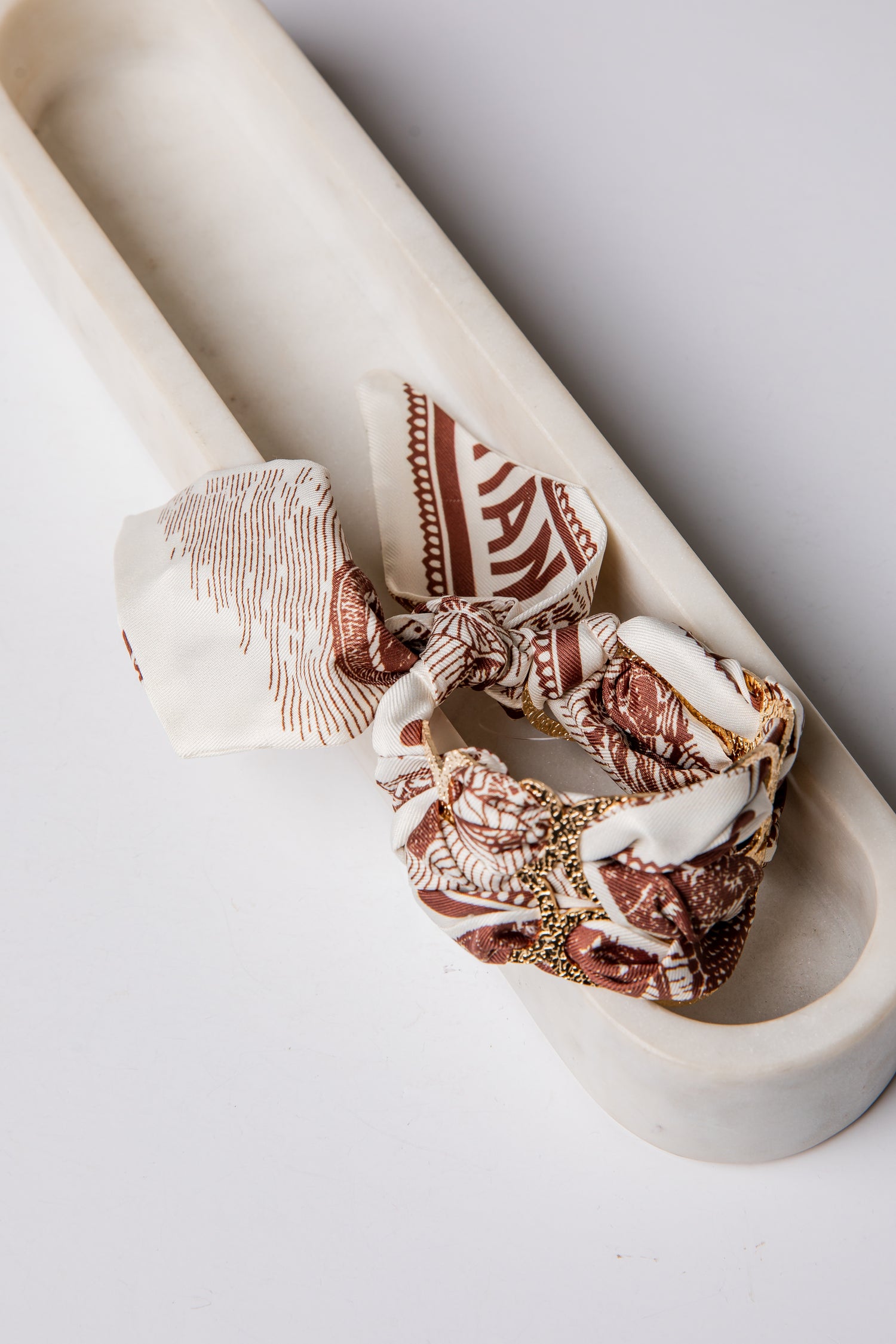Decorative bracelet with intricate patterns on a marble surface