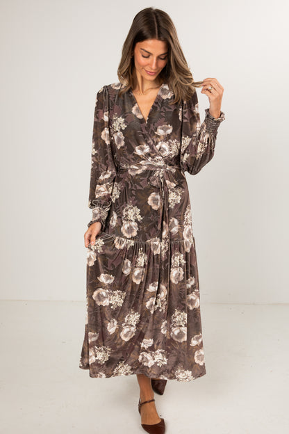 Woman wearing a floral dress against a white background
