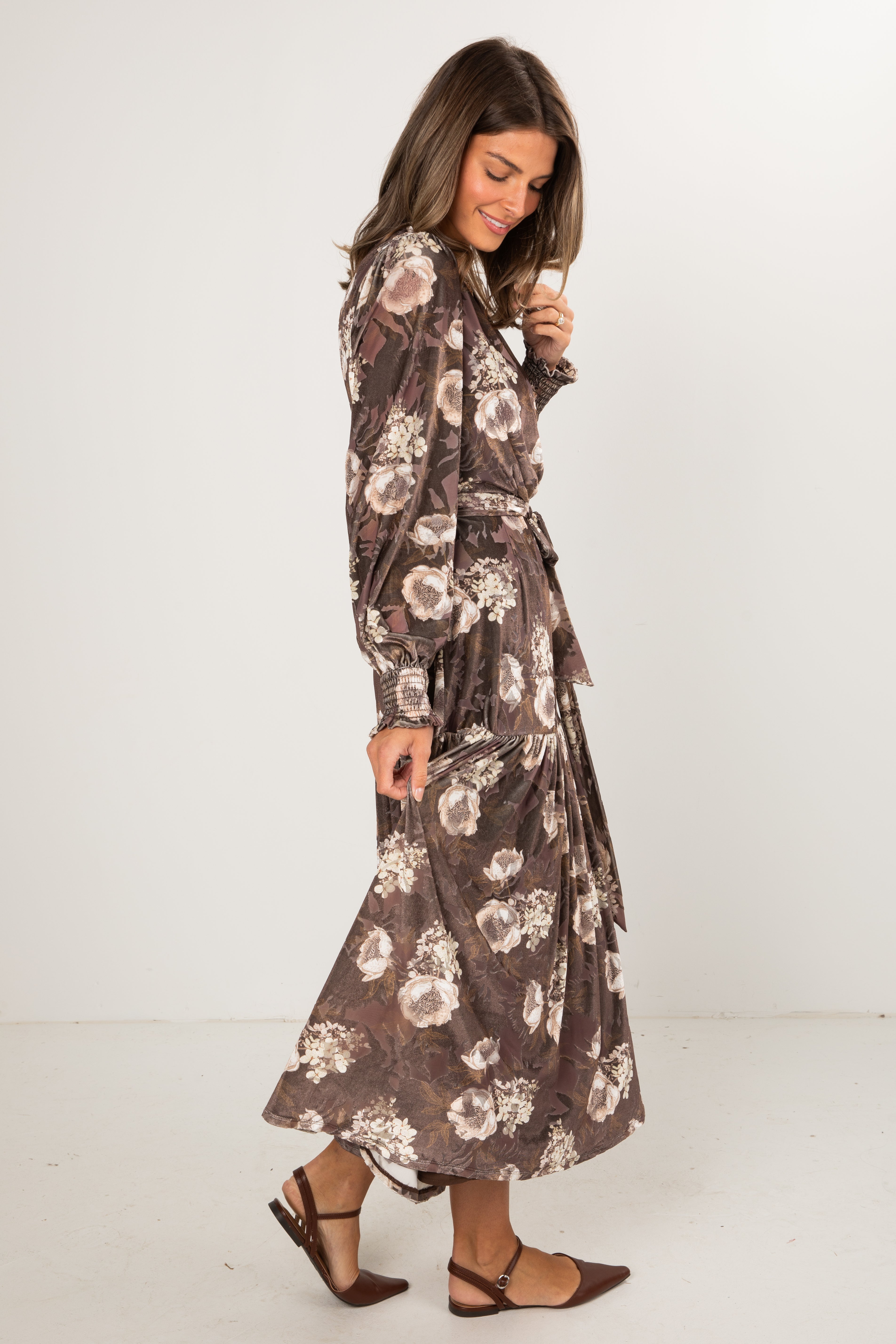 Woman wearing a floral dress with a white background