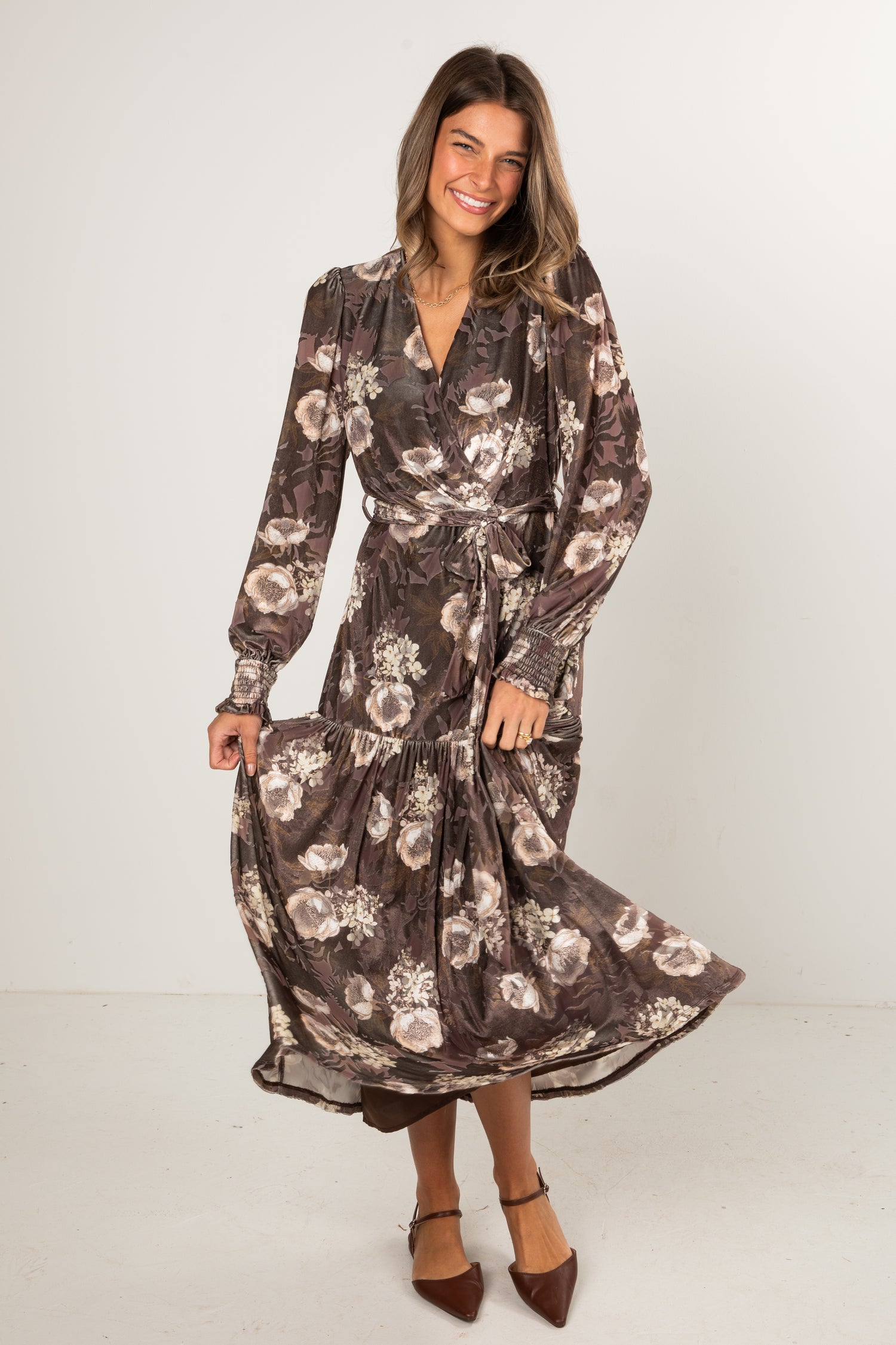 Woman wearing a floral dress on a white background