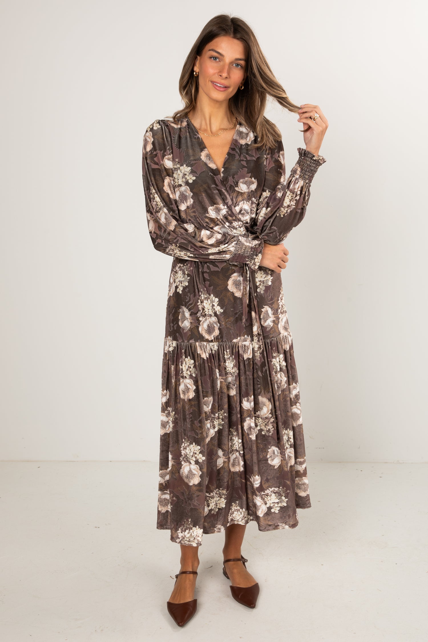 Woman wearing a floral dress against a white background