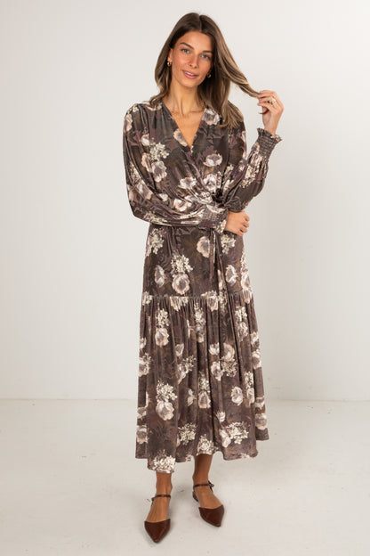 Woman wearing a floral dress against a white background