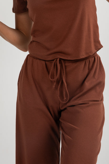 Brown ribbed top and pants set on a white background