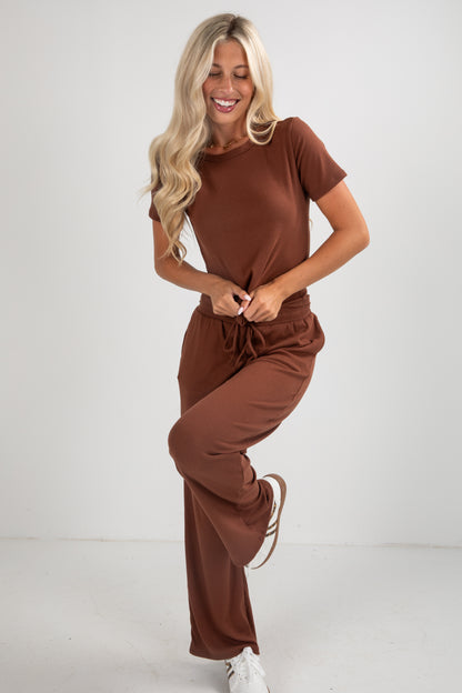 Woman wearing a brown outfit on a white background