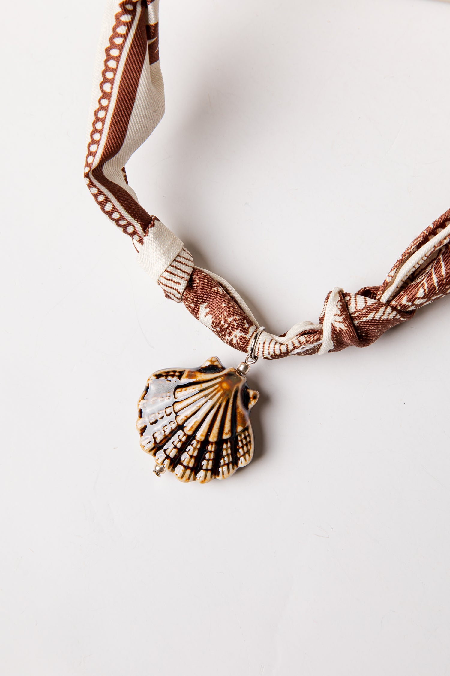 Necklace with a shell pendant on a white background