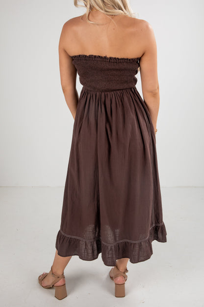 Brown strapless dress worn by a person on a white background