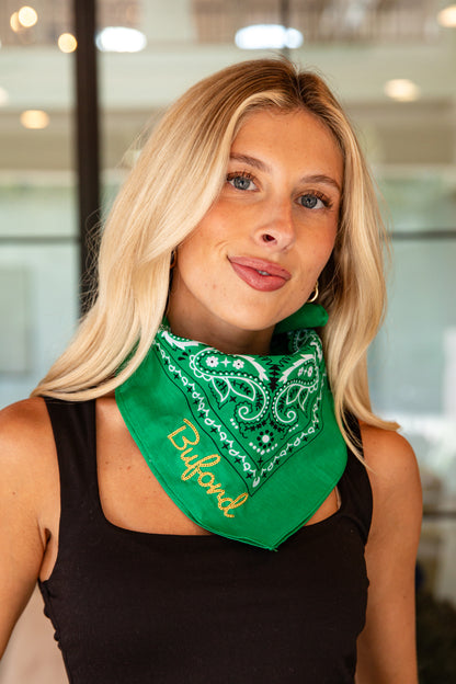 Woman wearing a green bandana with &