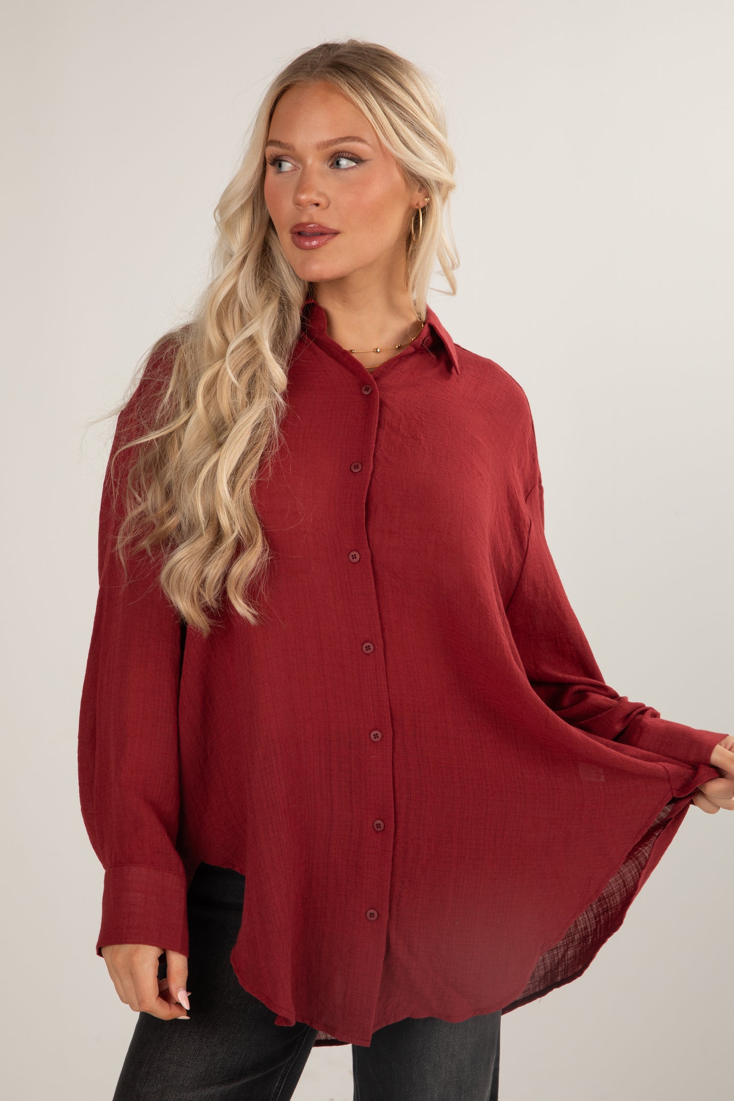 Woman wearing a red blouse with a plain background