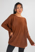 Woman wearing a brown sweater against a white background