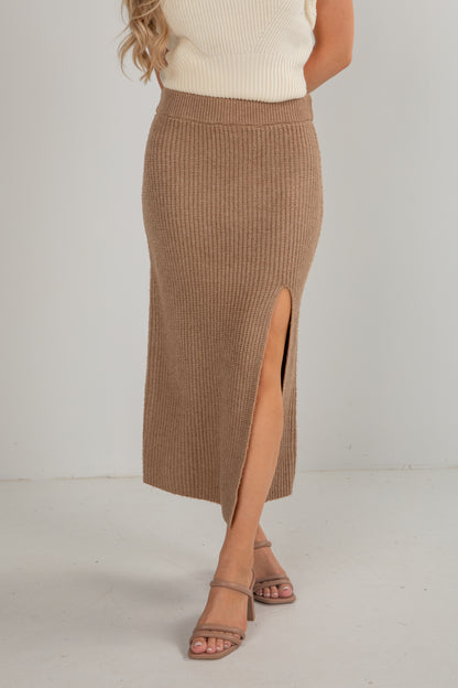 Brown ribbed skirt with a slit worn by a person on a white background