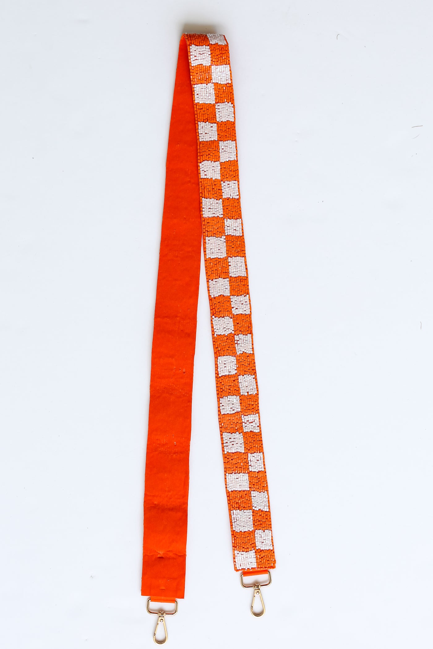 Orange + White Checkered Beaded Purse Strap flat lay