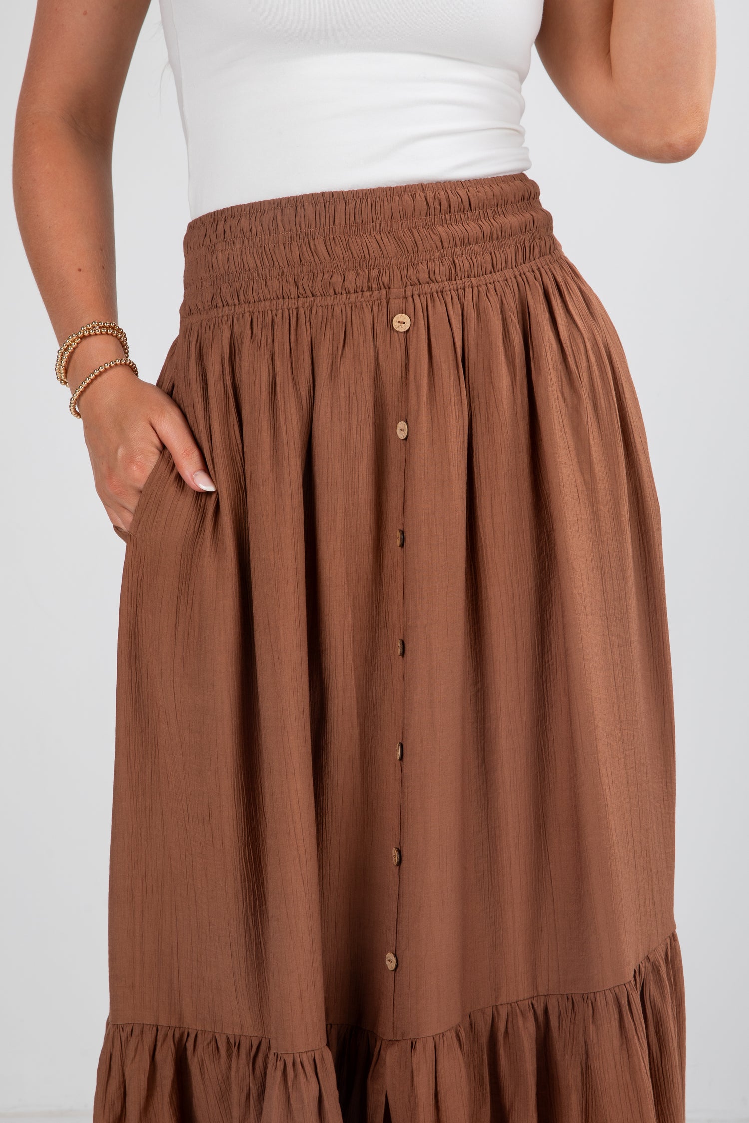 Brown skirt with button details on a white background