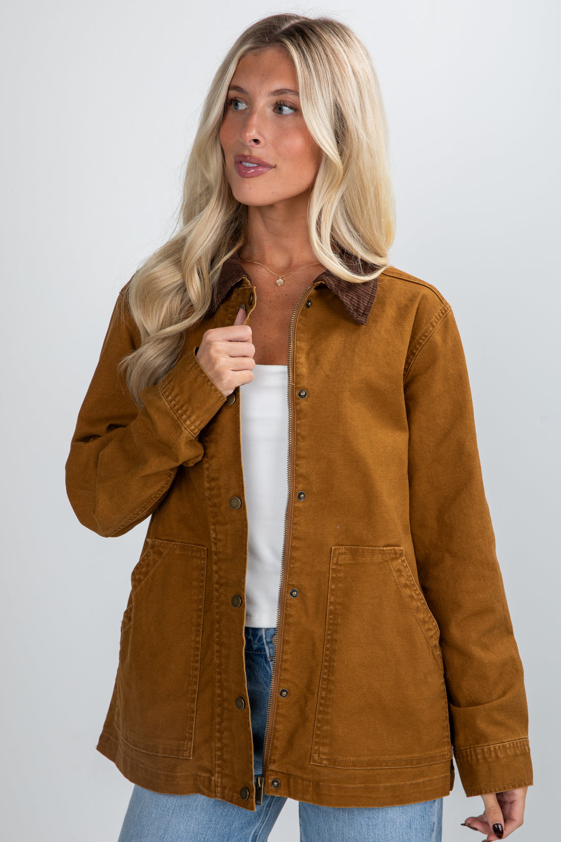 Woman wearing a brown jacket on a white background
