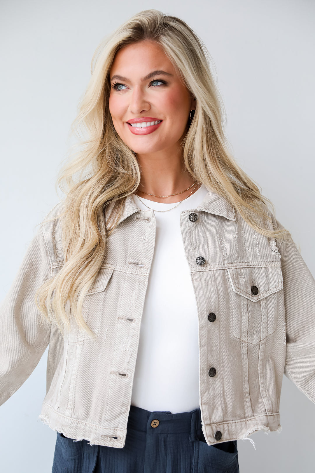 Taupe Distressed Cropped Denim JacketDefinite Icon Taupe Distressed Cropped Denim Jacket is lighweight, mid-crop fit, and the perfect spring layer. Taupe jacket. spring jacket.