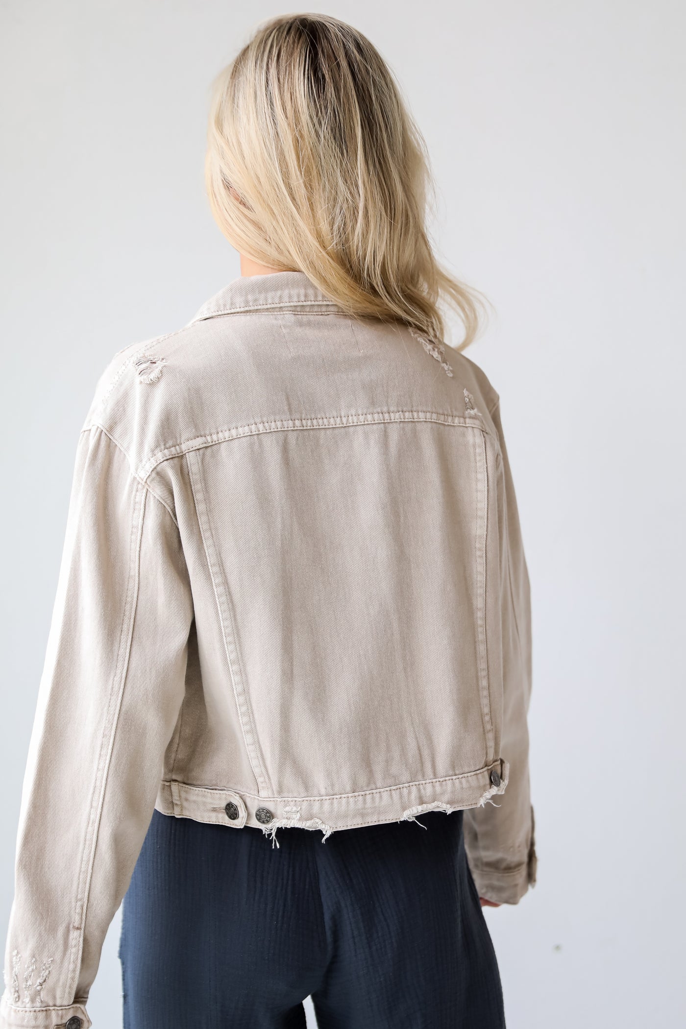 Definite Icon Taupe Distressed Cropped Denim Jacket is lighweight, mid-crop fit, and the perfect spring layer. Taupe jacket. spring jacket.distressed denim jacket