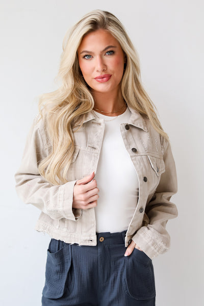 Definite Icon Taupe Distressed Cropped Denim Jacket is lighweight, mid-crop fit, and the perfect spring layer. Taupe jacket. spring jacket.cute denim jackets