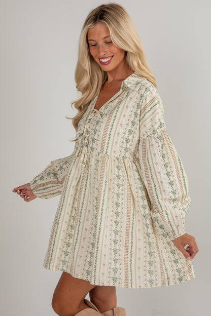 Woman wearing a floral dress against a plain background