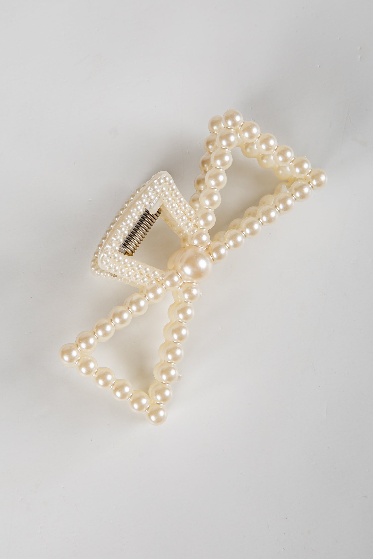Pearl hair clip on a light gray background