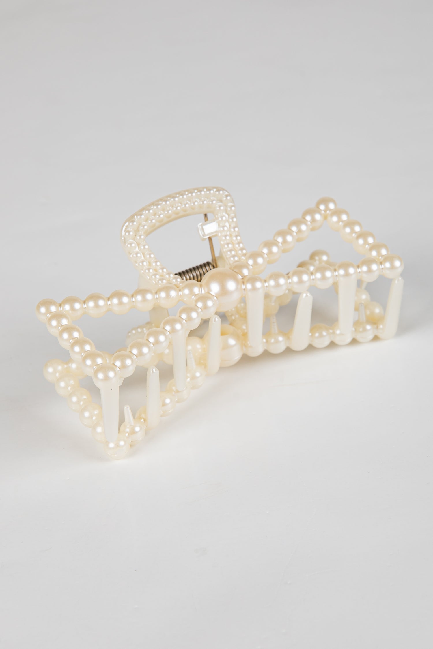 Pearl hair clip on a light gray background