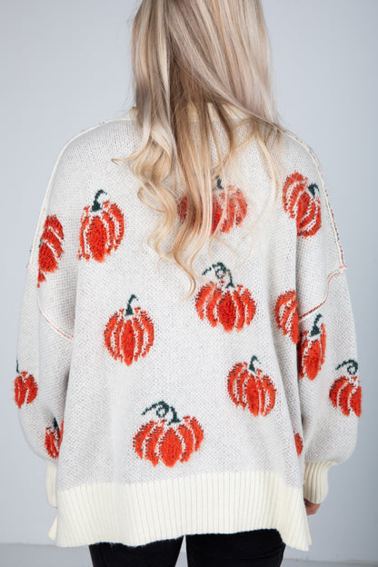 White sweater with red pumpkin patterns worn by a person with blonde hair.