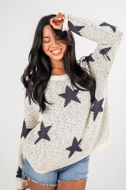 Woman wearing a star-patterned sweater against a white background