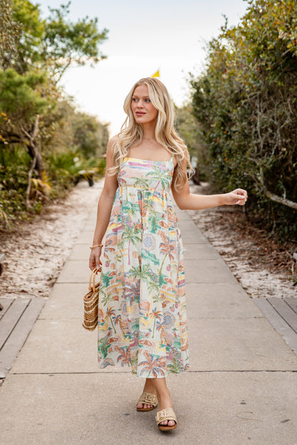 Woman in a floral dress walking on a path in a natural setting