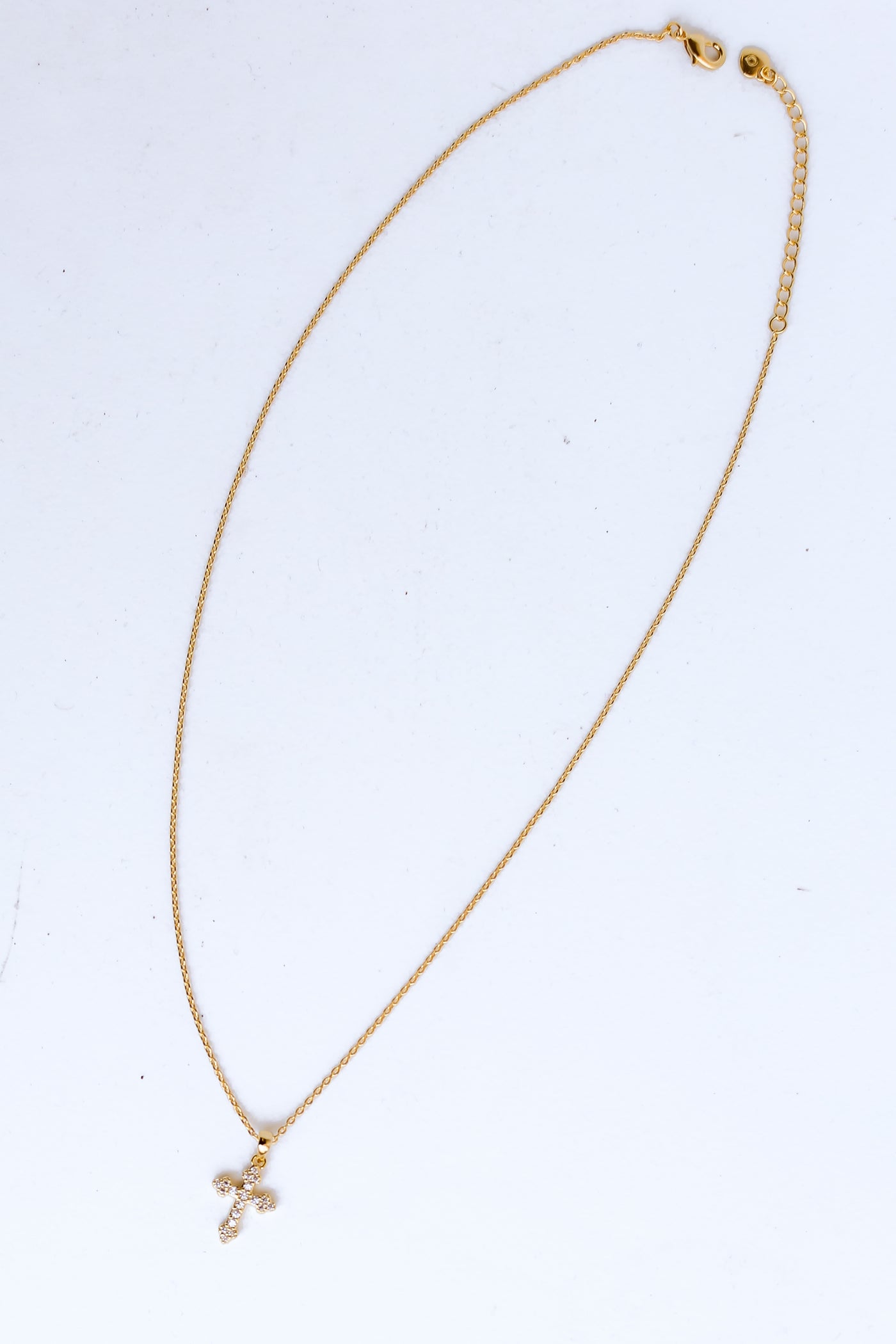 Gold Rhinestone Cross Charm Necklace flat lay