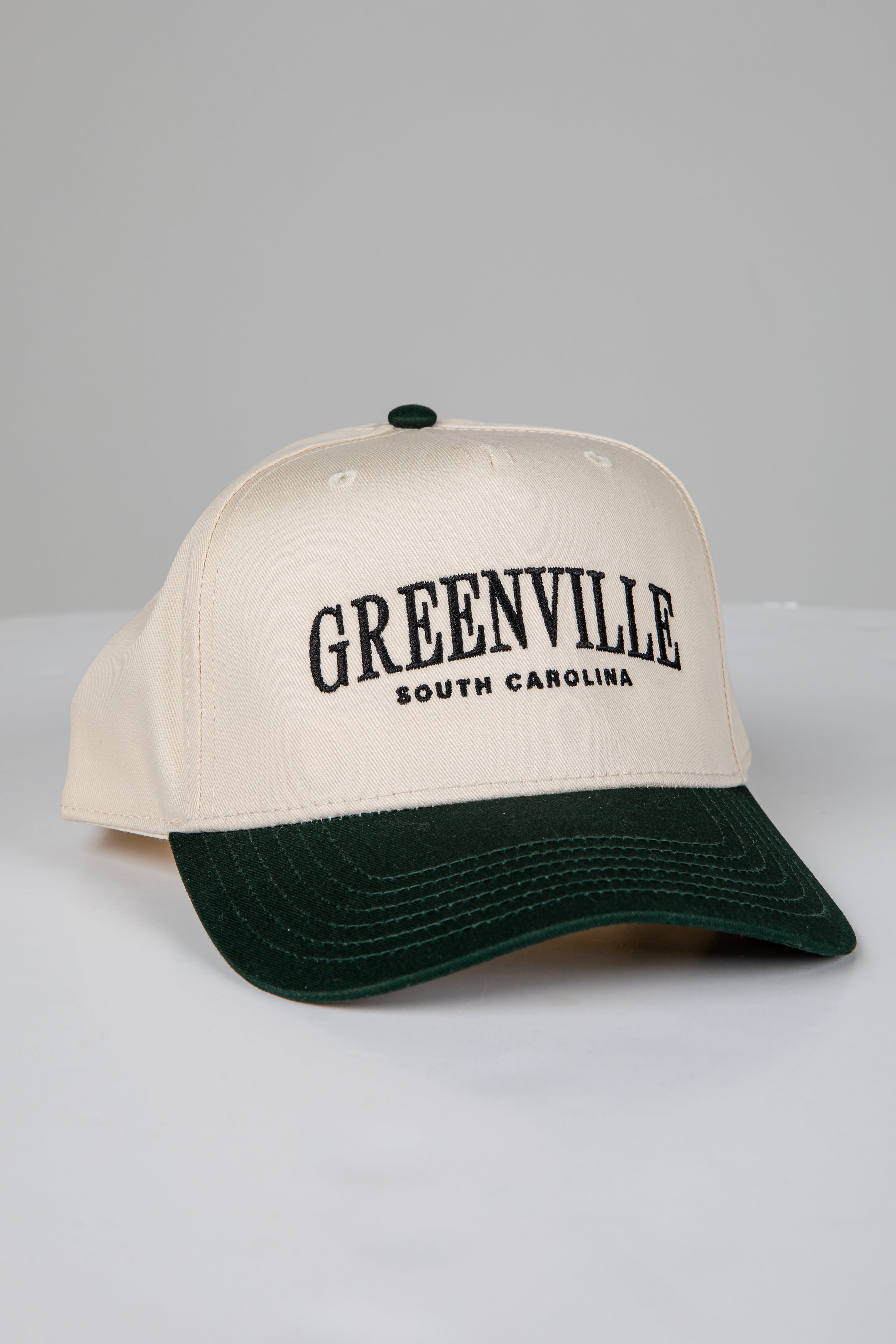 Beige cap with green brim and &