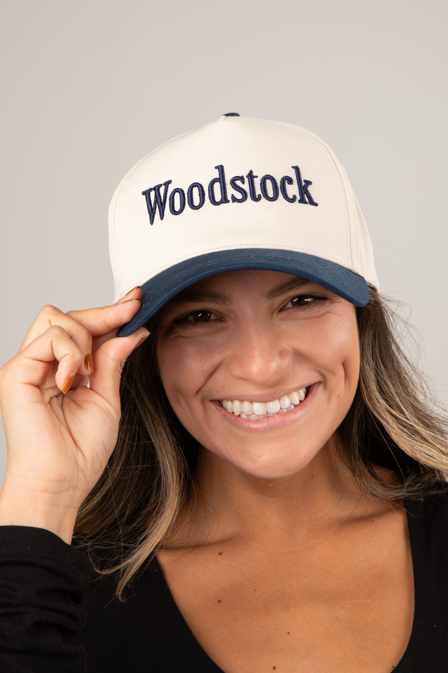 Woman wearing a white cap with &