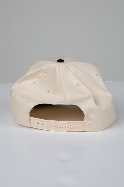 Beige cap with a black button on a light gray background