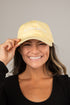 Woman wearing a yellow cap with &