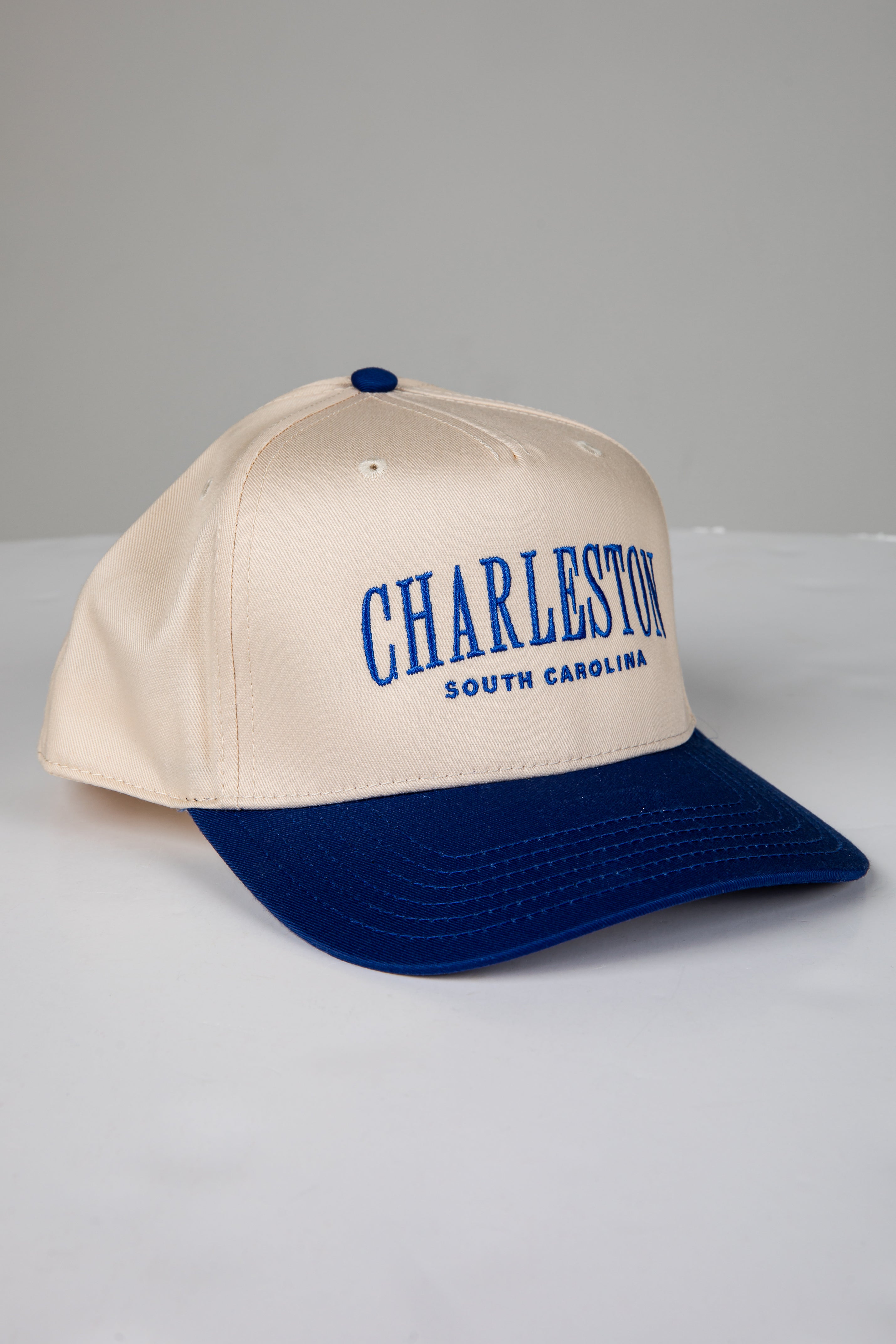 Beige and blue cap with &