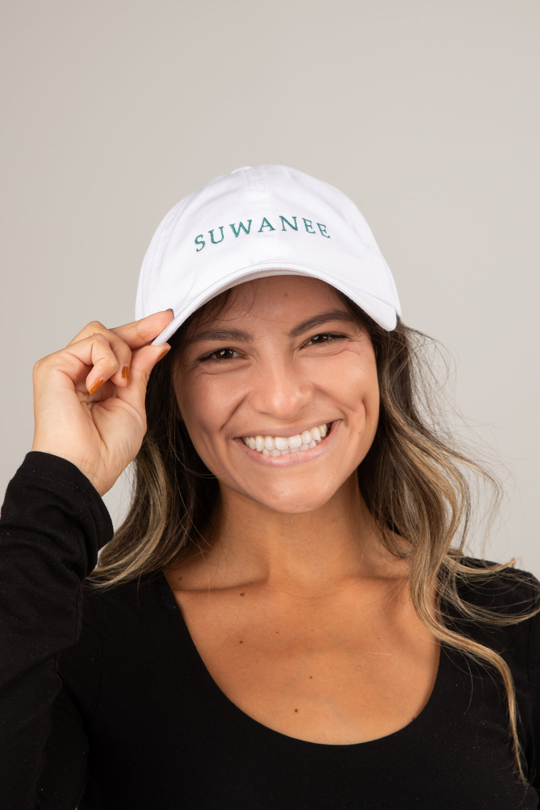 Woman wearing a white cap with &