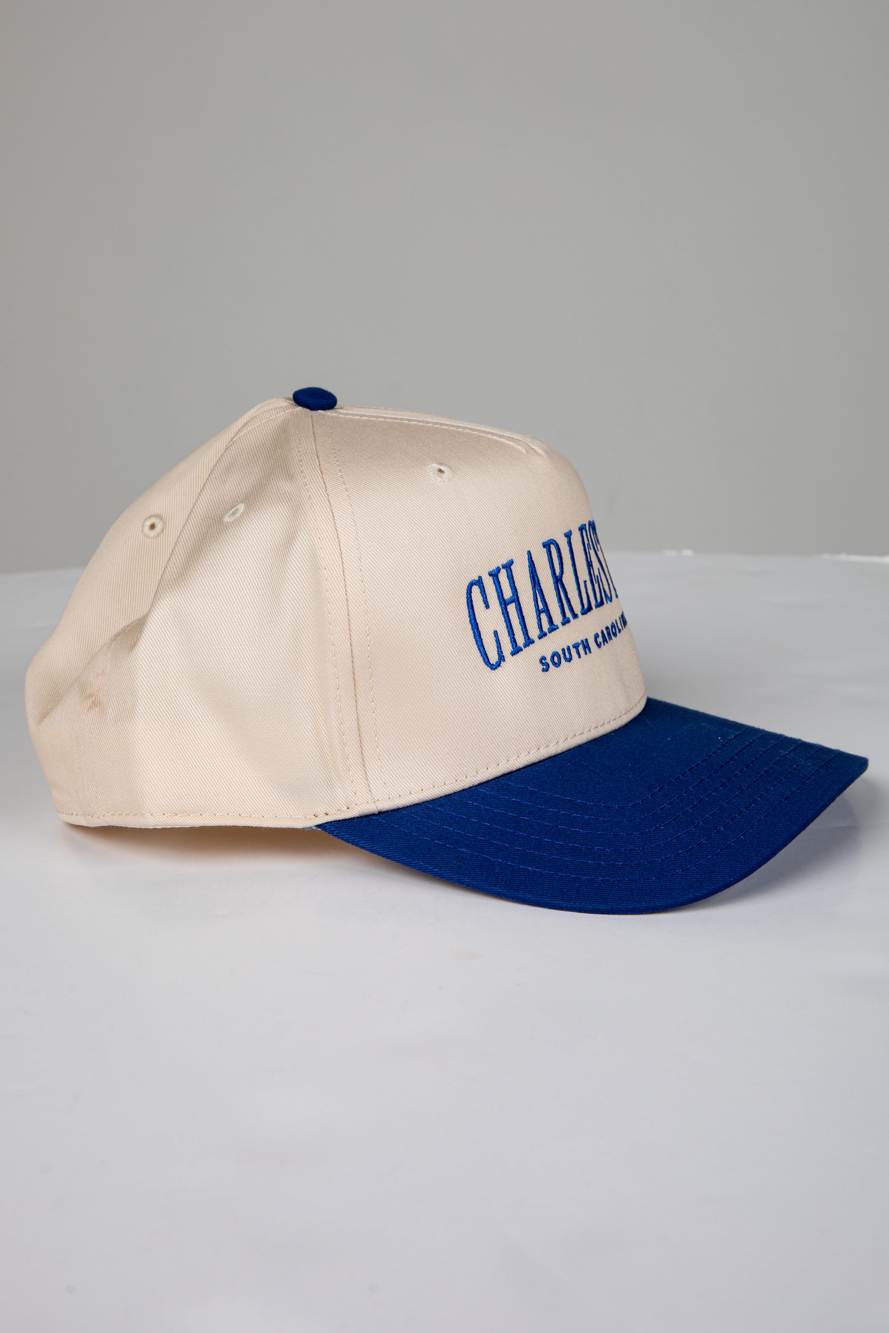 Beige and blue cap with &
